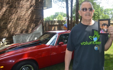 Robert Blackwell, a double lung recipient, holds up a picture of his donor, William Wayne McGee IV