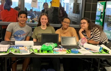 Young adults at info table