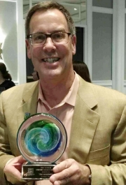 Tim Makinen holding the Trey Schwab Coaching Award
