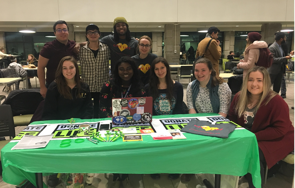 Group of college students at info table