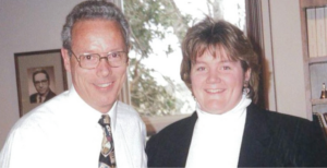 Man in shirt & tie with woman in business attire