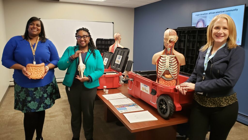 Three women with anatomy demo items