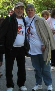 man and woman at outdoor event, smiling at the camera