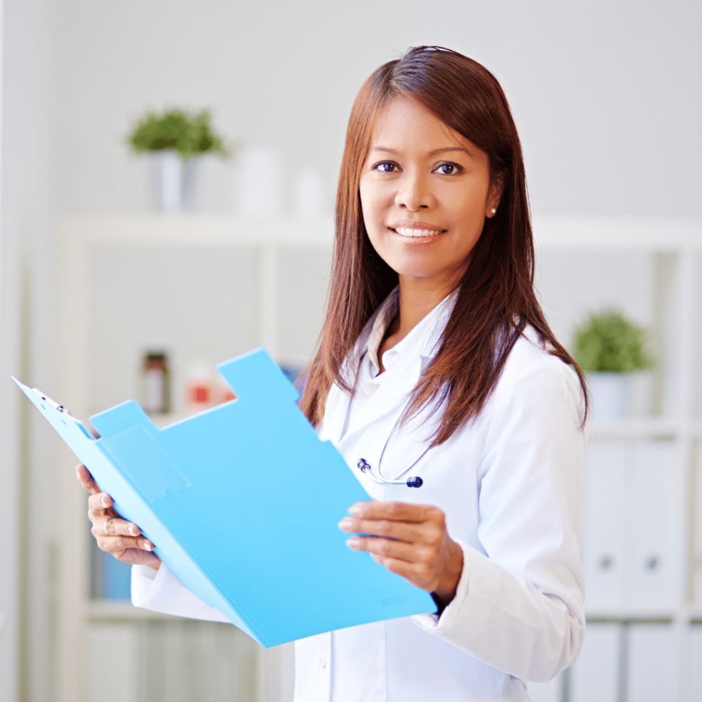 Female doctor holding open chart looking at the camera