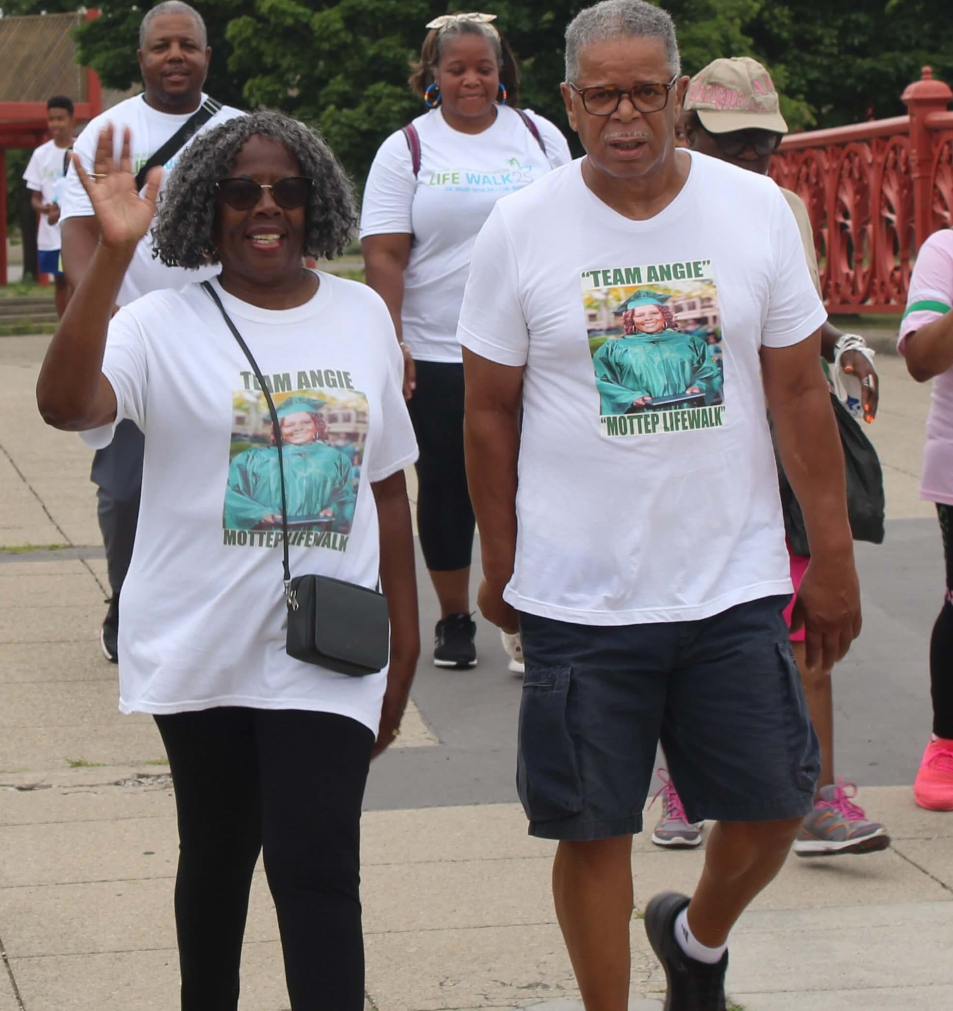Artelia Griggs and Donnie Parker wave as they finish the 5K walk