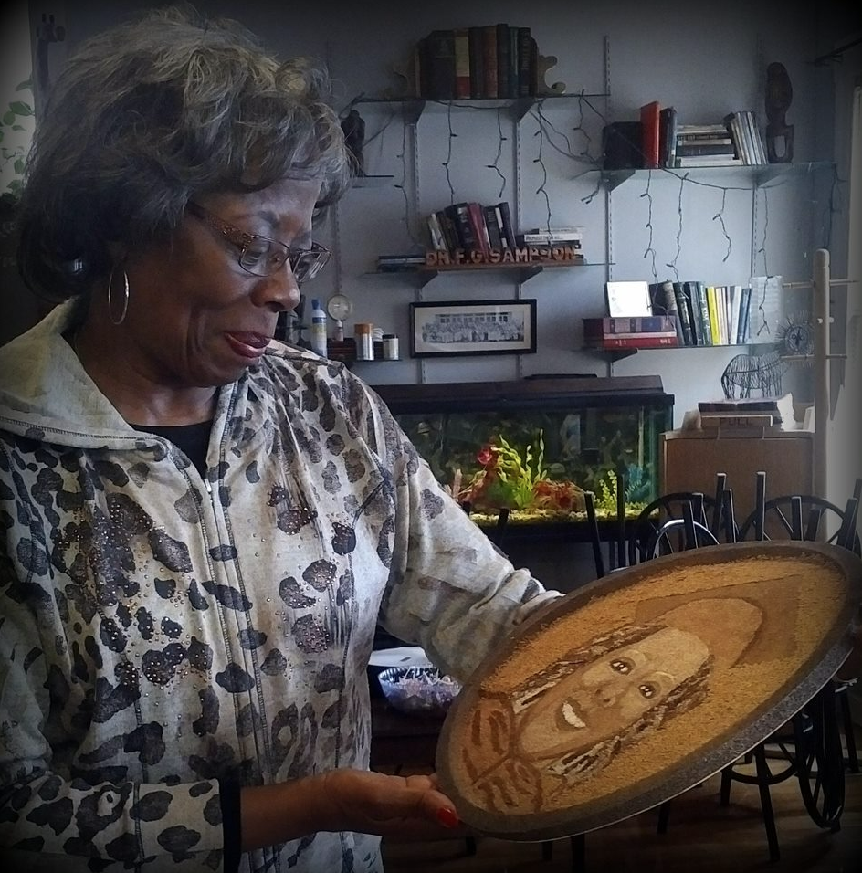 Woman holding a round floragraph with the image of her daughter on it