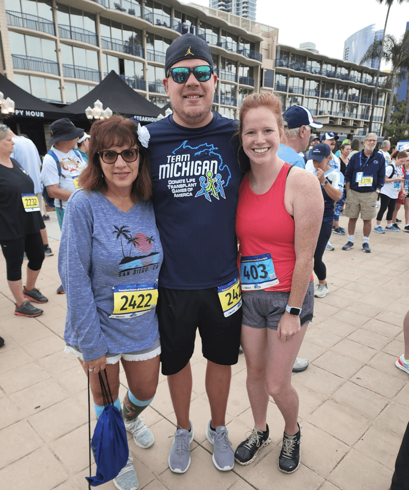 A young man, his mother and his fiancee are dressed to walk/run the 5K at the Transplant Games of America