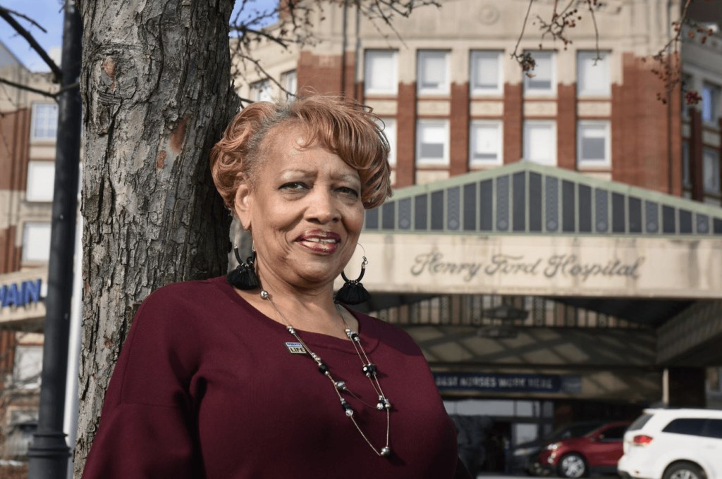 Aarolyn McCullough stands in front of Henry Ford Hospital, where she received her liver transplant in 2011.