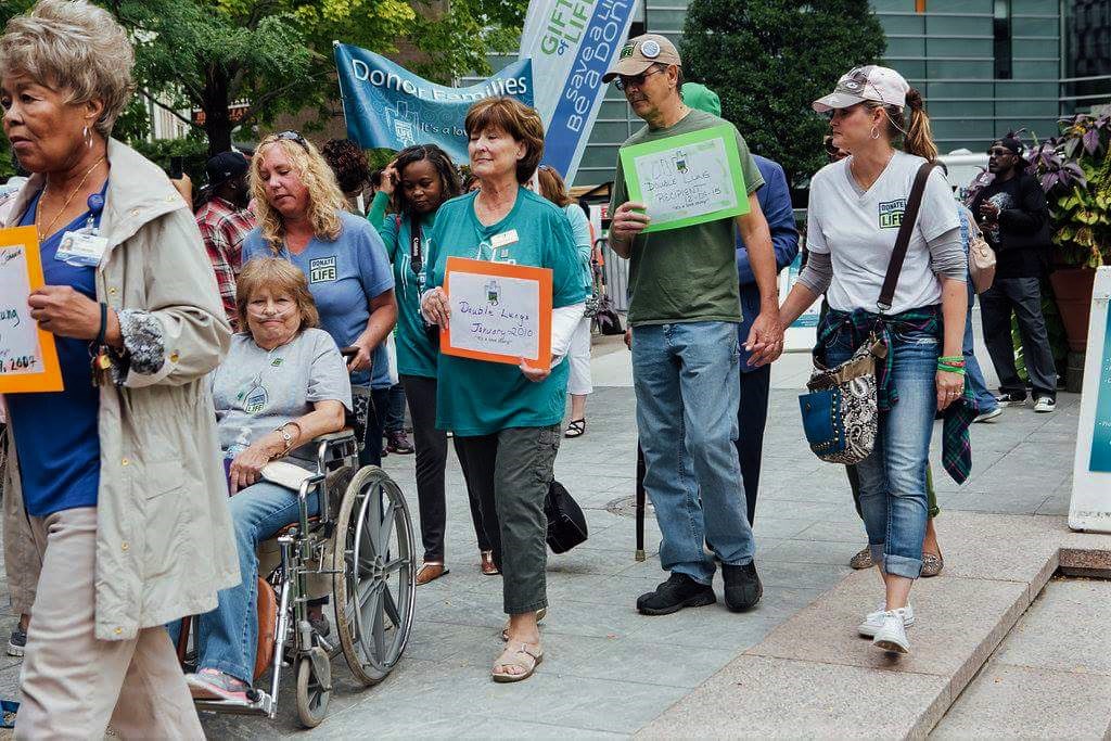 Donation supporters walk in the March of Honor at the state Capitol building