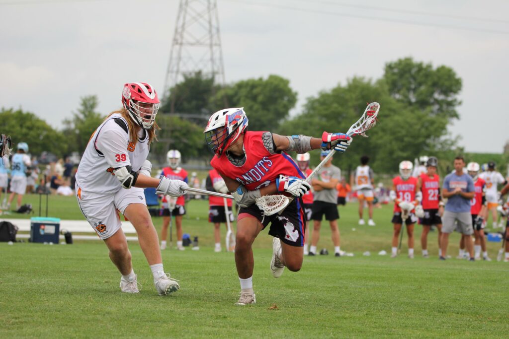 Tristan Johnson playing lacrosse on the field with his teammates