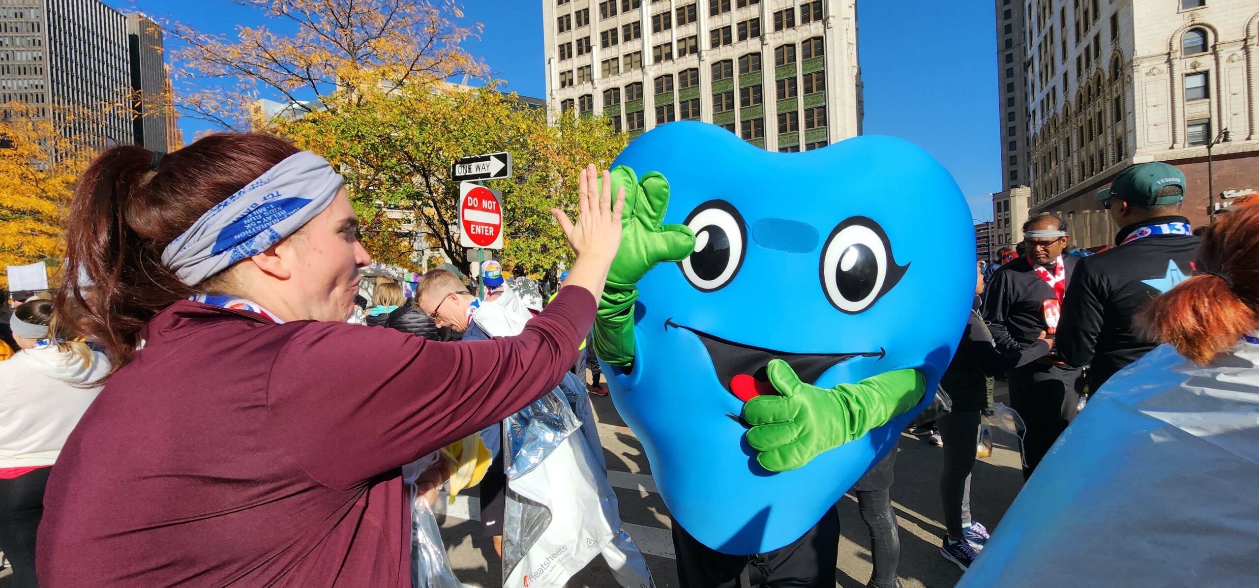 Hartley T. Heart, Gift of Life's chief mascot, gives a high five to a passing runner.