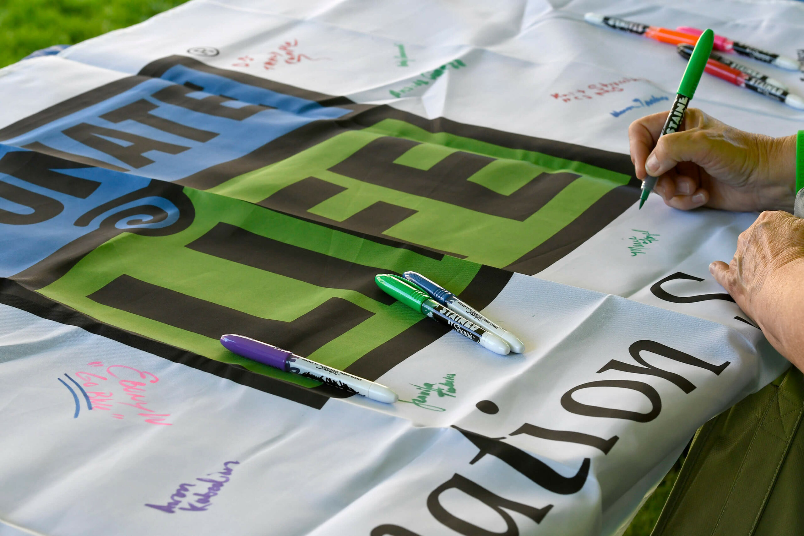 Someone signing the Donate Life flag