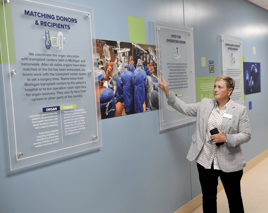 Betsy Miner-Swartz shows the donor tribute mural to a group at Gift of Life