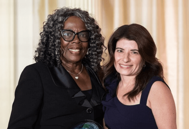 Artelia Griggs, donor mother, receiving an award from Christine Peiter, Gift of Life employee and tissue graft recipient