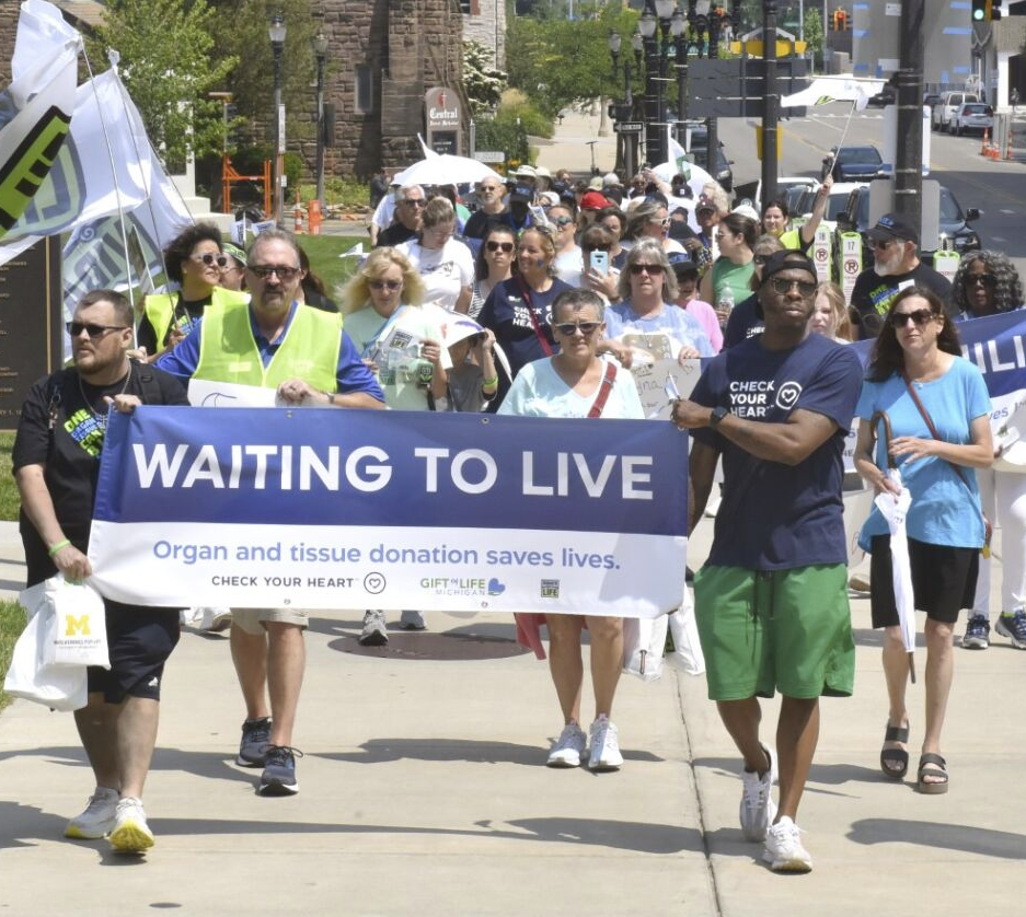 Group of patients waiting for organ transplants carrying a banner reading "Waiting to Live" along the Capitol sidewalk