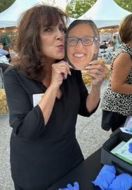 Woman holding up a photo of Sherry's face