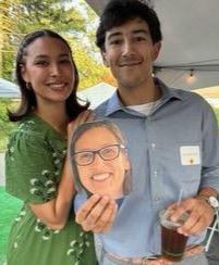 Man and woman holding up a photo of Sherry's face