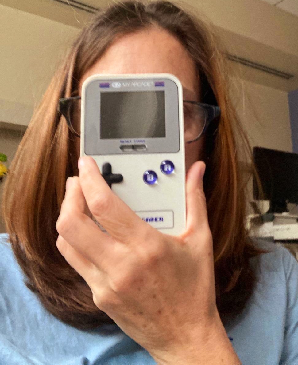 Sherry holding a Gameboy system in front of her face