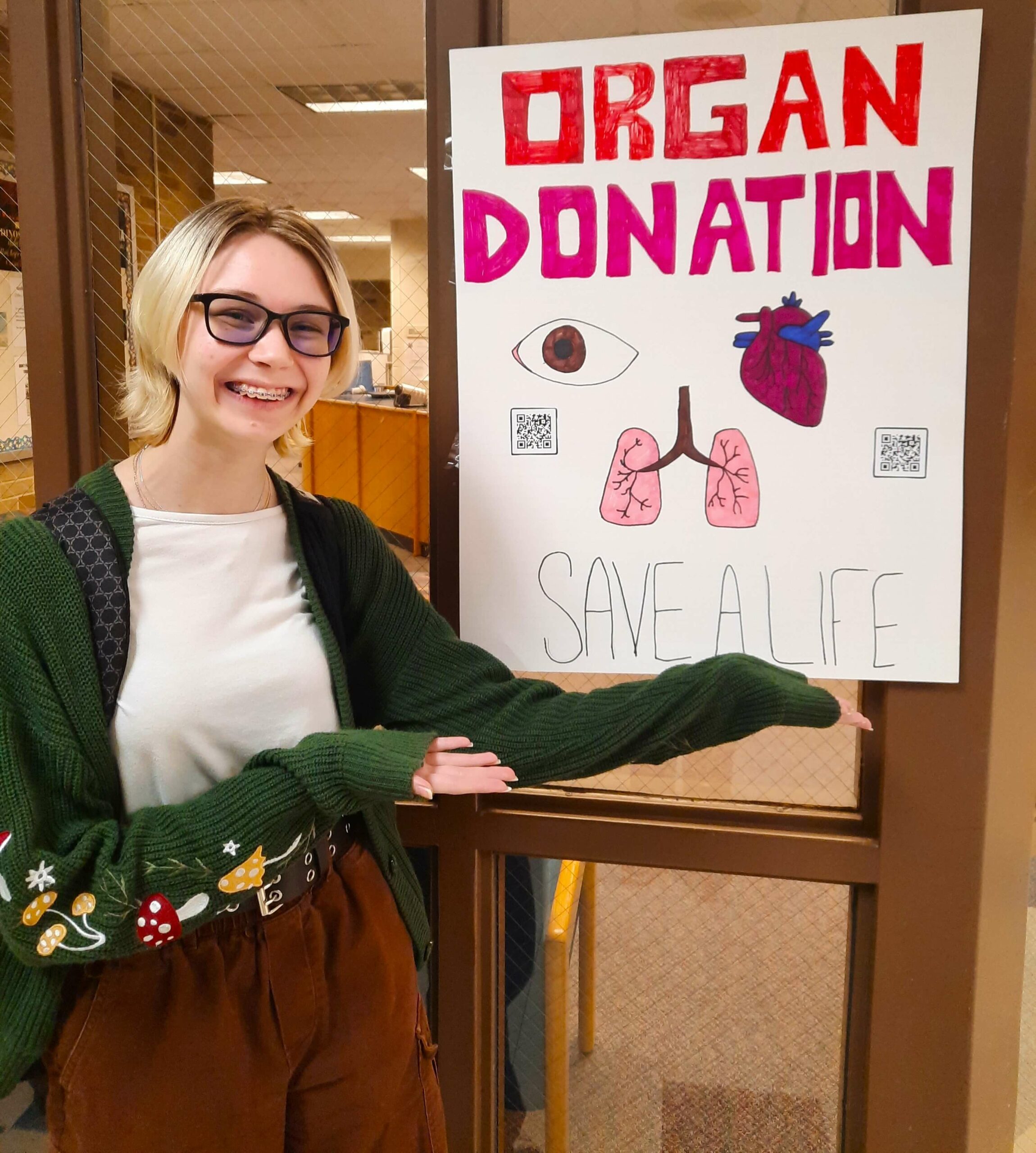 HOSA student with her poster promoting organ donation