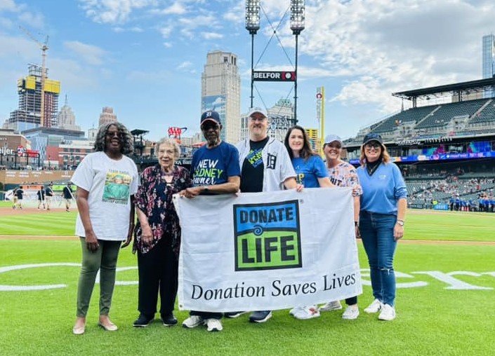 Gift of Life Michigan President and CEO Dorrie Dils with other supporters of organ, eye and tissue donation on the field at Comerica Park