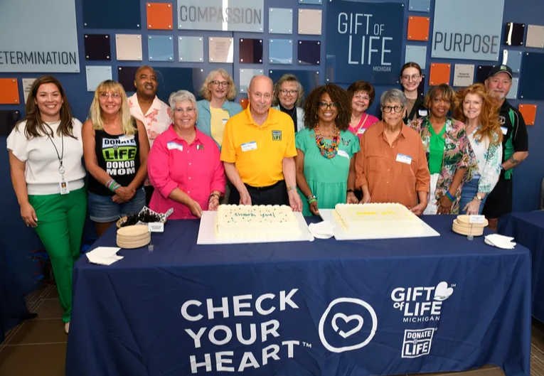 Gift of Life's super volunteers gathered around two cakes