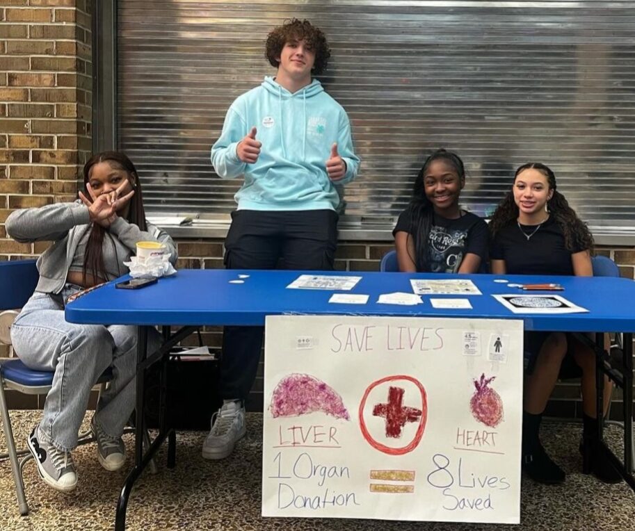 Students staffing an information table during the HOSA Challenge