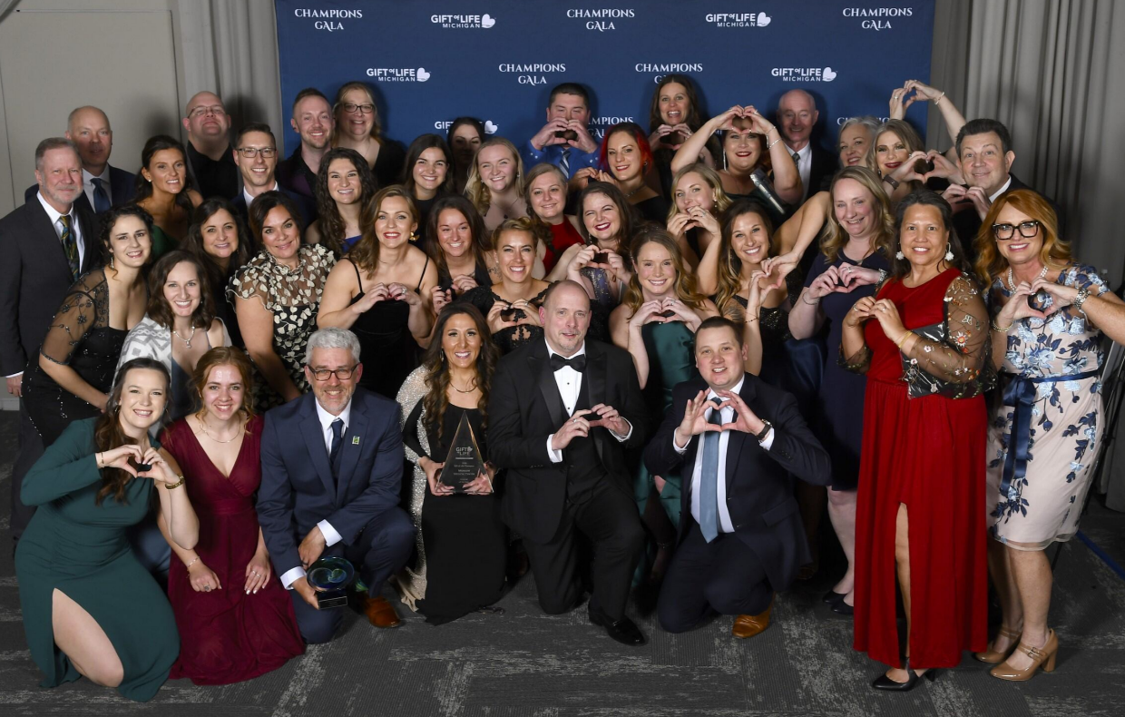 Munson Medical Center staff with their hands in the shape of hearts at the 2024 Champions Gala