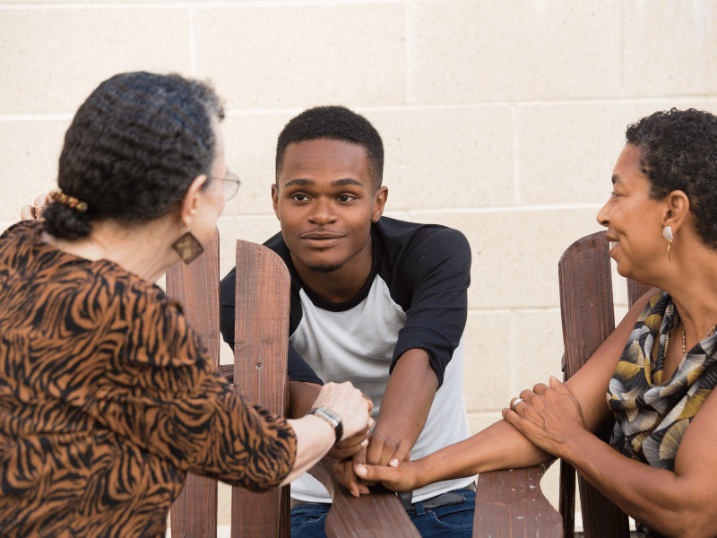 Three members of a family (son, mom, grandma) gathered in discussion