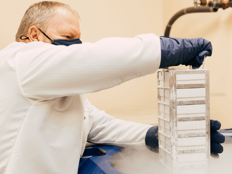 Walt pulls samples from a liquid nitrogen freezer in the laboratory