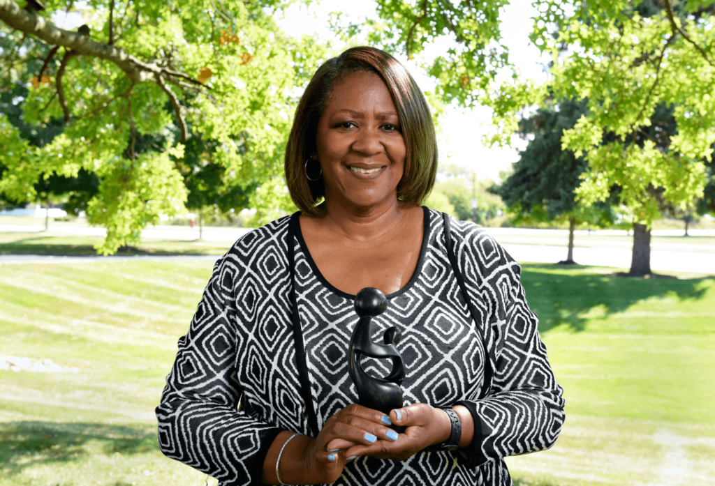 Sheila Alston holding her DAISY Award for outstanding nursing care