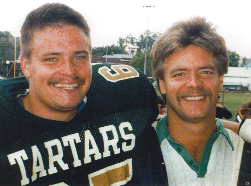 Tim Schramm with his father, Roy, at a Wayne State University football game Tim played in.