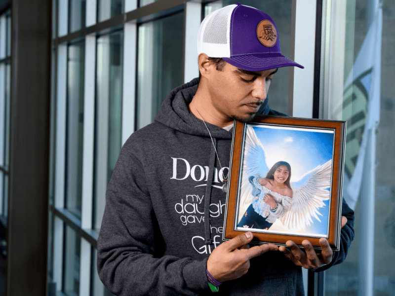 Omar Garcia holds a framed photo of his daughter, Ceci, who was a donor at age 11.