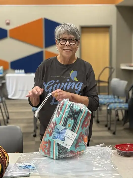 Liver transplant recipient Marge Del Greco holds a newly created comfort blanket.