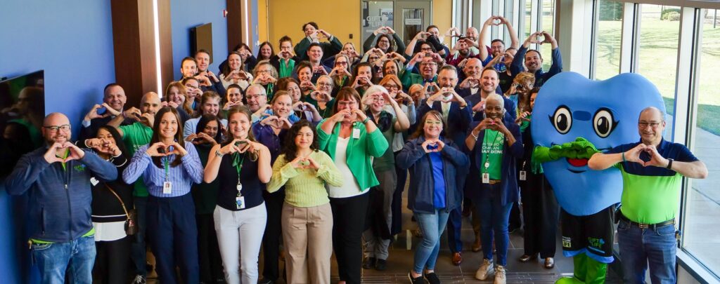 Gift of Life staff holding their hands in the shape of hearts