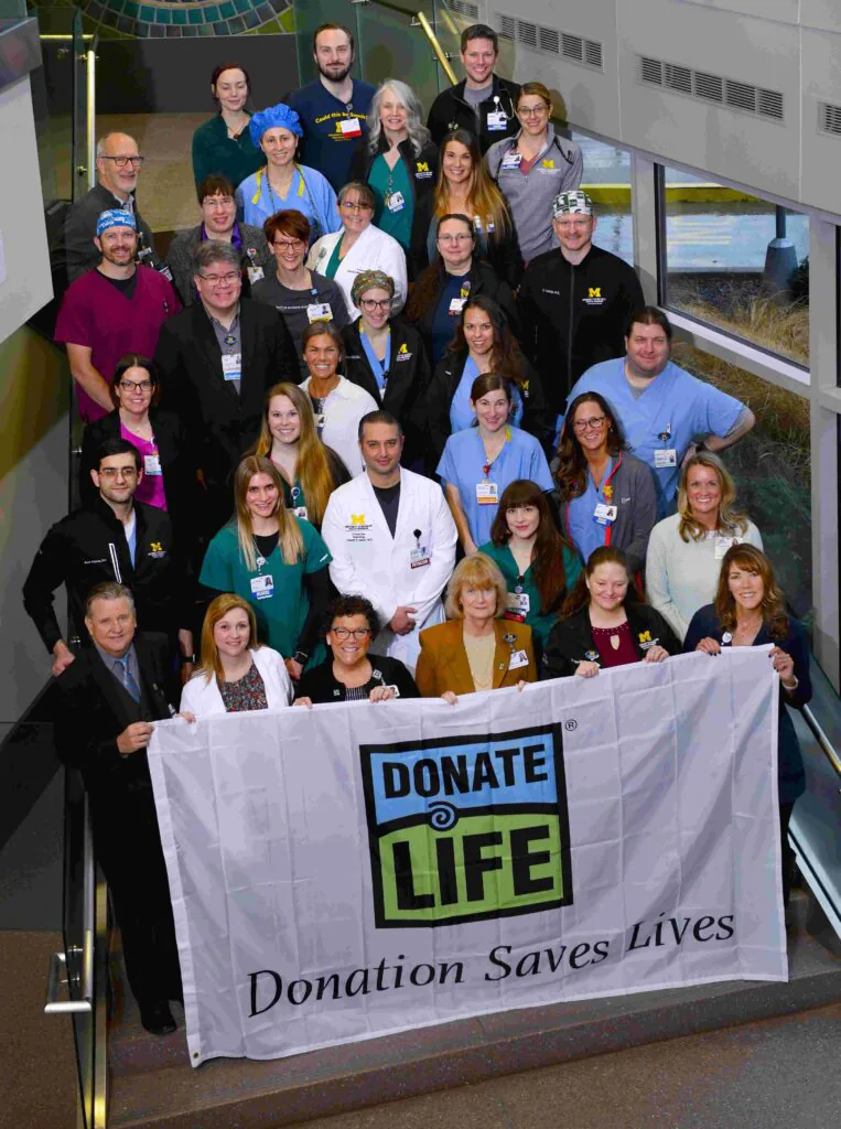Staff from UM Health Sparrow-Lansing holding a Donate Life flag
