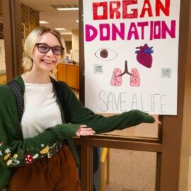 HOSA student with her poster promoting organ donation